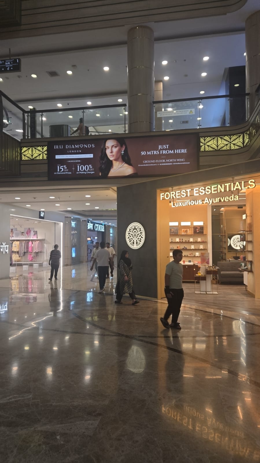 Mall corridor — branded LED billboard visible from main thoroughfare
